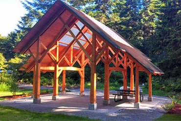 A wooden outdoor shelter shines with morning light