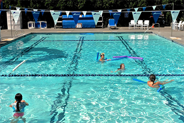 Swimmers enjoy an outdoor pool