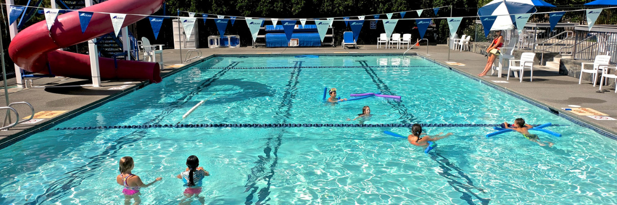 People swimming in an outdoor pool