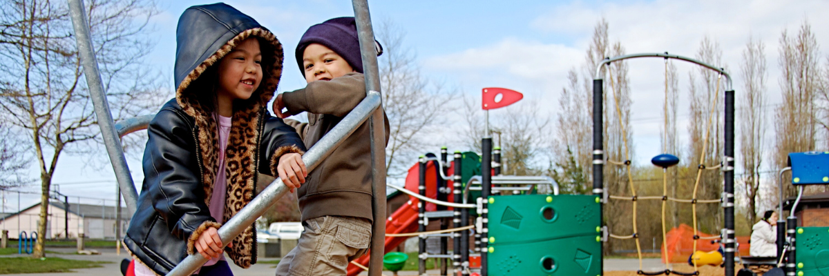 Two children enjoy a new playground