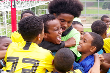 Children celebrate after scoring a soccer goal