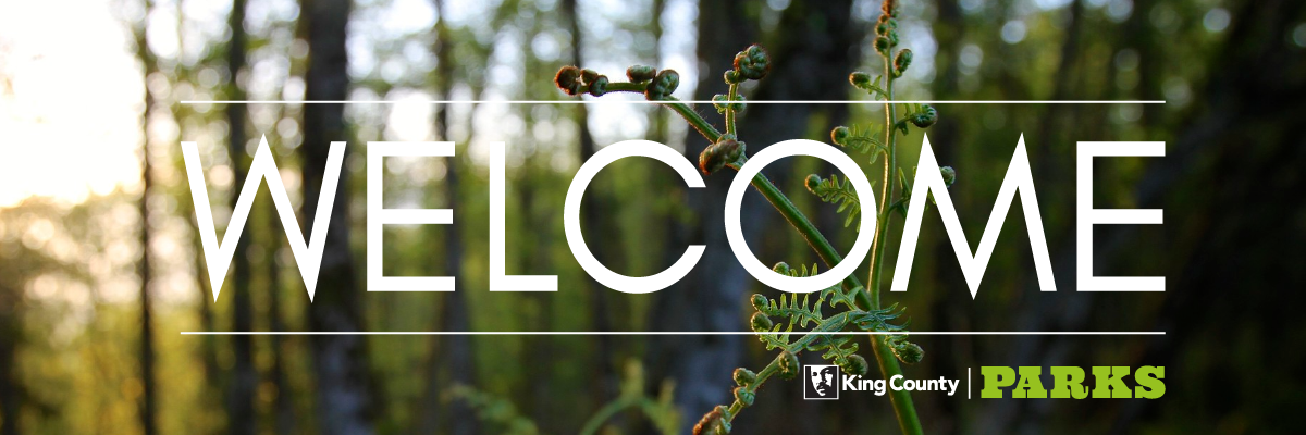 "Welcome" over a image of a green bud in a forest with the King County Parks logo