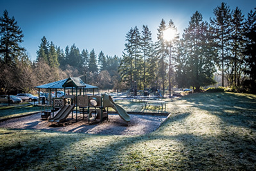 A frost-covered playground at Big Finn Hill in morning sun