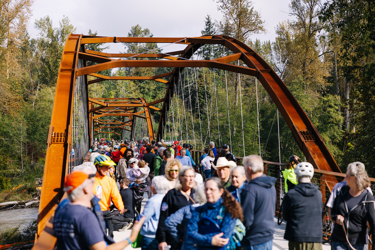 Hundreds of walkers and bikers cross the foothills trail bridge during its opening celebration event.