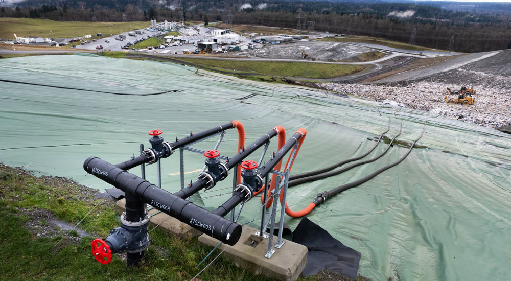Image showing landfill gas piping with the Cedar Hills Regional Landfill in the background