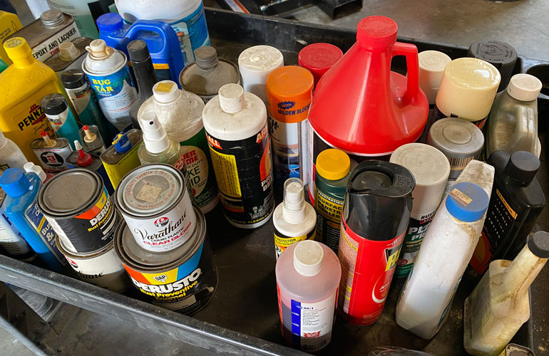 Image of several hazardous chemicals in a push cart.