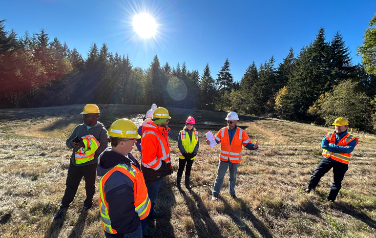 A group of King County Solid Waste Division employees inspects the Vashon Island compost expansion work