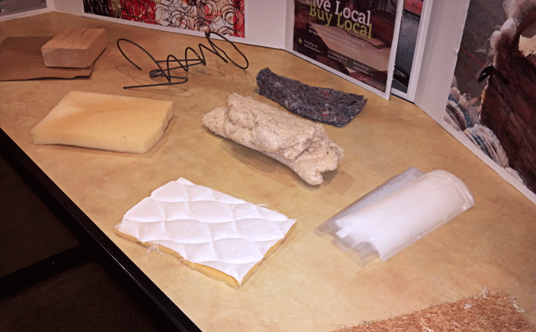 Image showing mattress components (cover, padding, springs) on a table after disassembly
