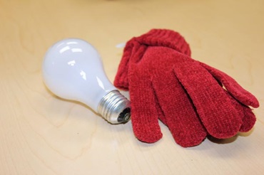 Materials for making penguin ornaments from lightbulbs and old gloves