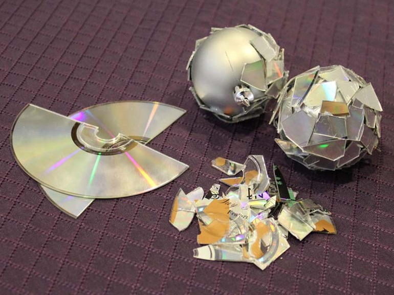 Transform faded ornaments into disco ball ornaments with old CDs
