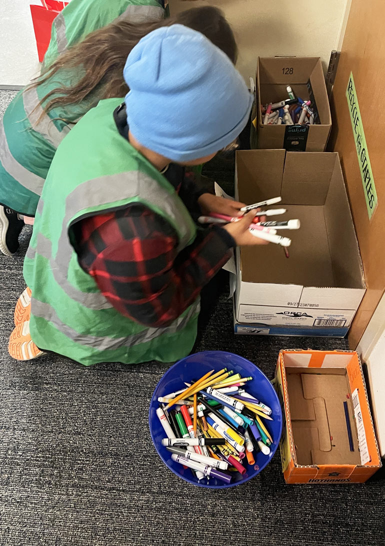 A student at Audubon Elementary School sorts markers