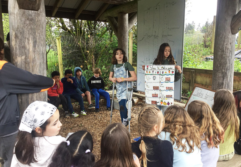 Students at Chatauqua Elementary School teaching their community about how to plant a garden.