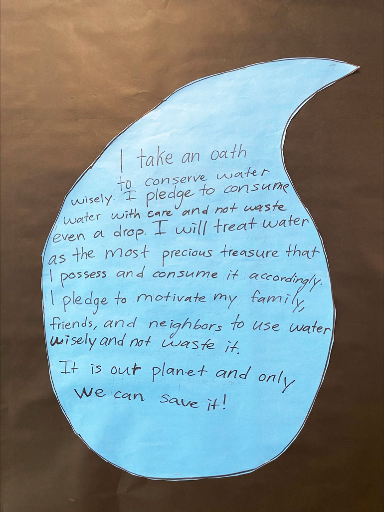 A hand-drawn cover for a Water Reduction pledge book at Ella Baker Elementary School
