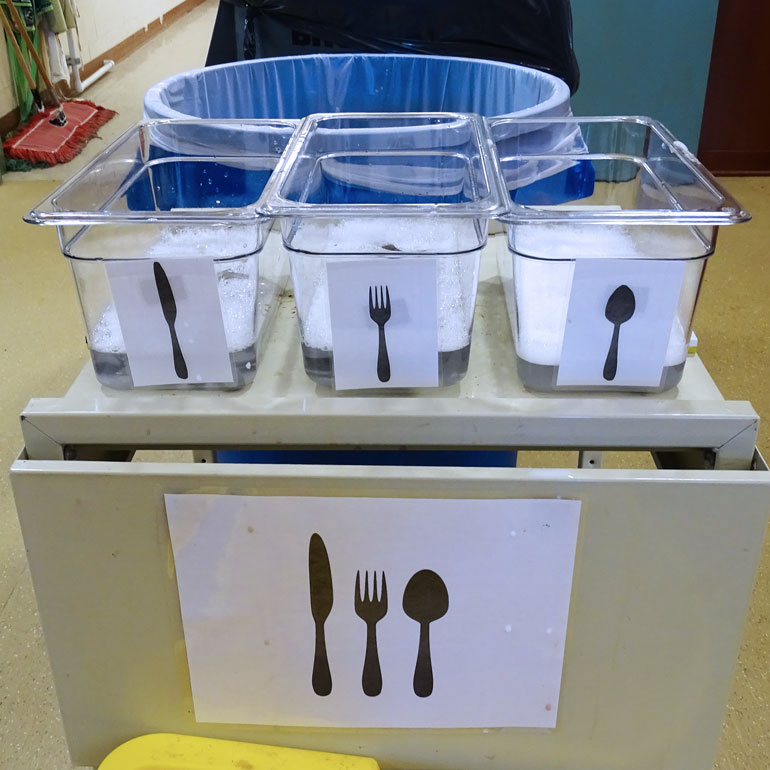 Bins for reusable, washable utensils in school cafeteria