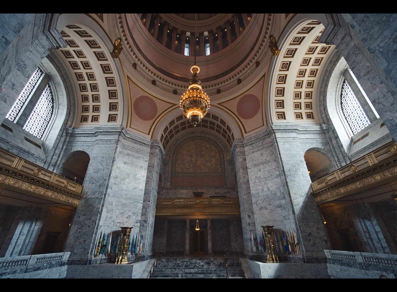 An image inside the Washington State Capitol bulding in Olympia, Washington featuring a stone hall with archways