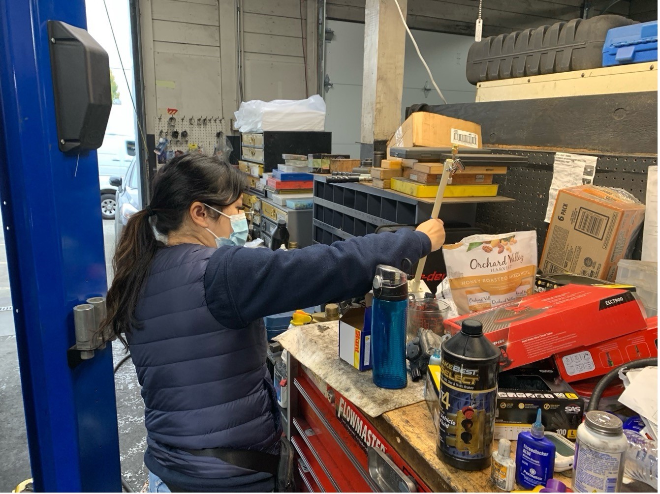 A University of Washington researcher evaluates hazardous materials in products in an auto body shop