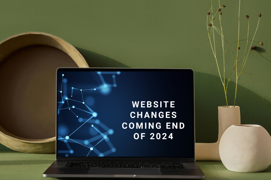 A computer sits on a desk with on-screen text that reads "Website changes coming end of 2024"