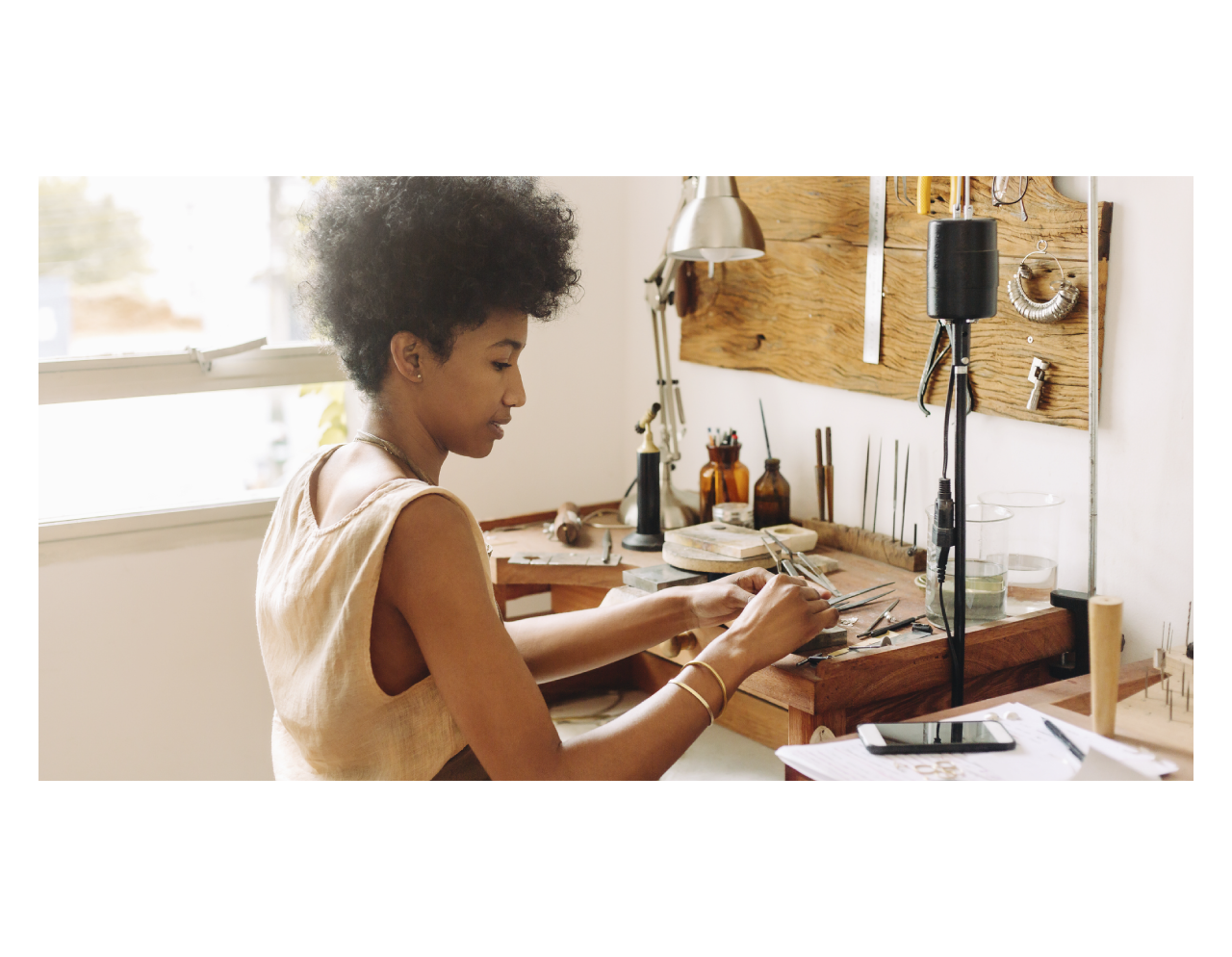 A Black woman makes jewelry as a hobby