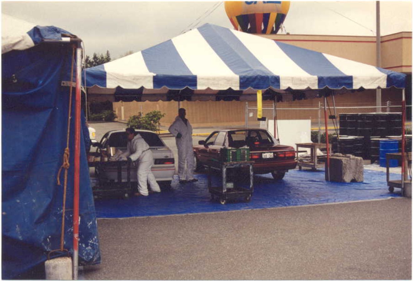 Workers sort hazardous waste at an early Wastemobile event