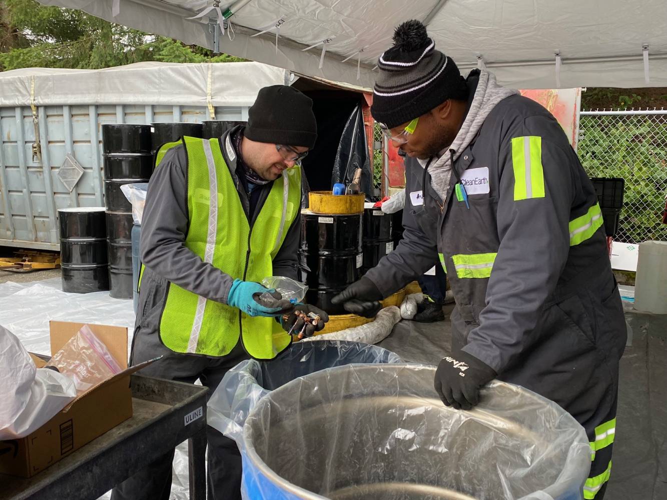 Two employees sort batteries at a hazardous waste collection event