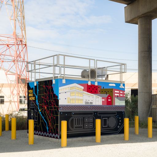 Art painted on a cement block structure showing buildings above ground and an artistic representation of machinery used to manage wastewater flows