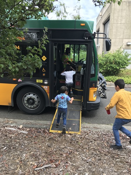 Elementary school students running to get onto the wheels to water bus.