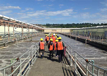 Students walking over a bridge during a south plant tour