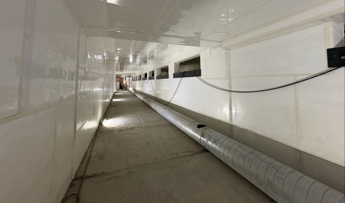 New passive weir system (long square white passage with rectangular opening near the top) works like the overflow drain in a sink or bathtub. 