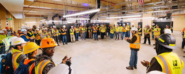 A group of West Point staff, contracts and officials wearing safety vests and hard hats celebrating the project completion milestone. 