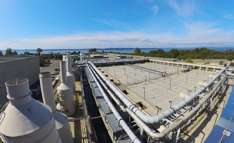 View of the top of the sedimentation tanks with blue sky.