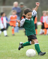 Young girl playing soccer.