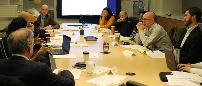 Photo of a Public Defense Advisory Board meeting with people sitting around a table.