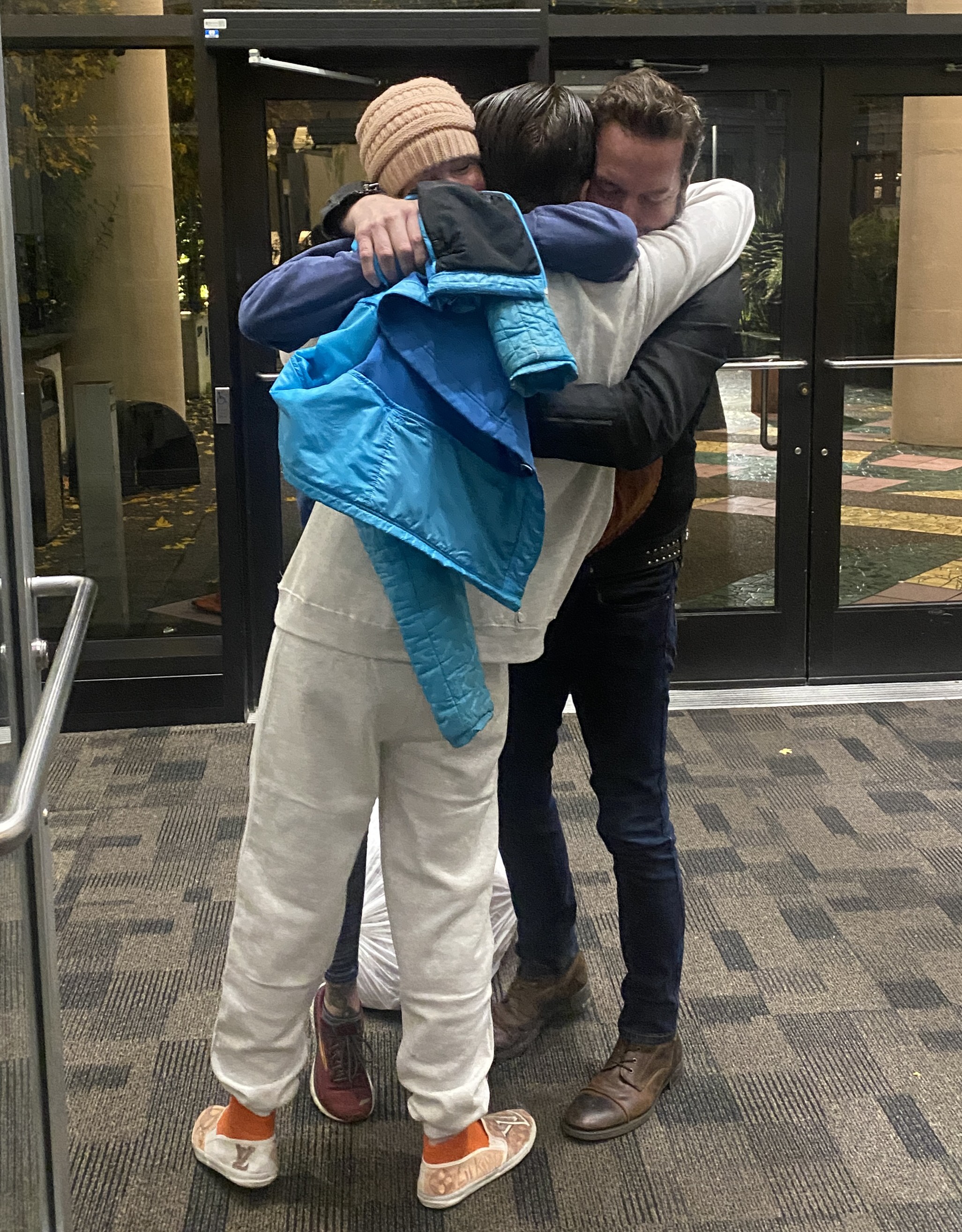 Client Kai Light embraces his parents after a jury found him not guilty on a homicide charge