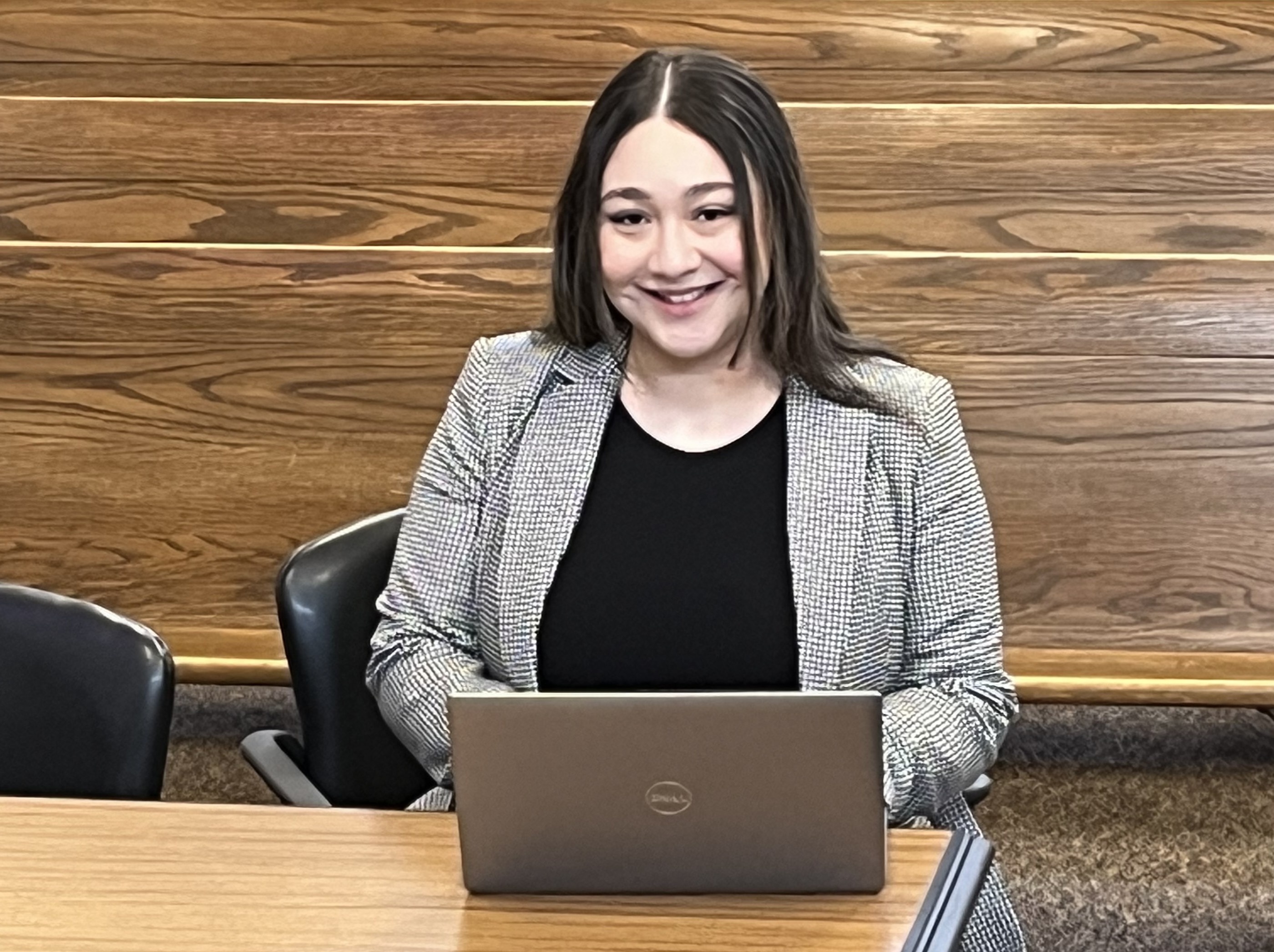 Misdemeanor attorney Zulen Pantoja-Ortega seated at counsel table in Redmond district court wearing a grey jacket and black shirt