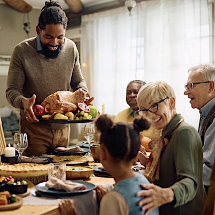 Man serving turkey for a holiday meal