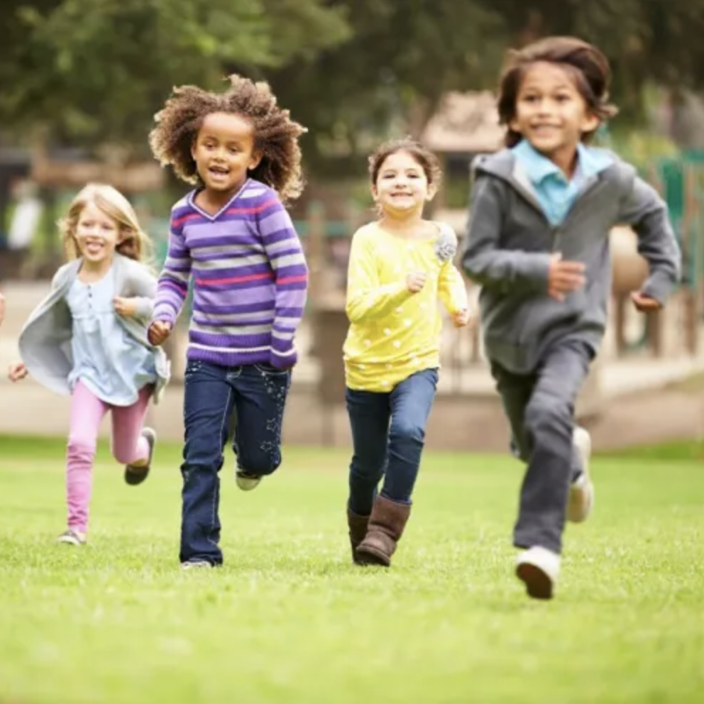 School-age children at running on a lawn