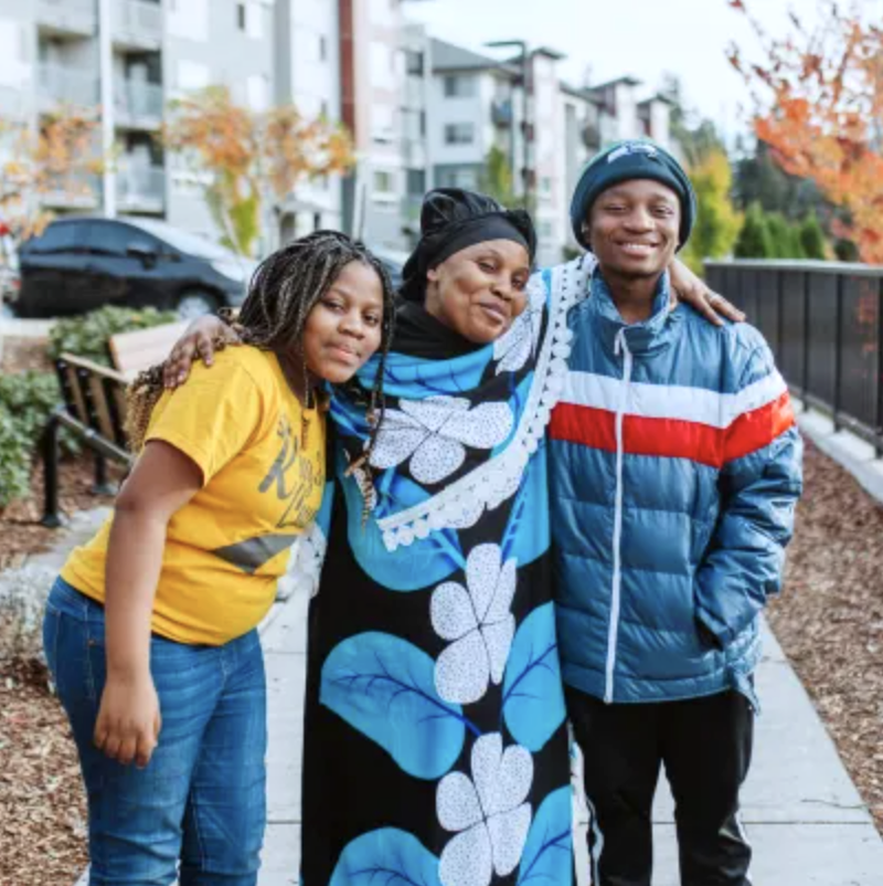A mom standing with her daughter and son