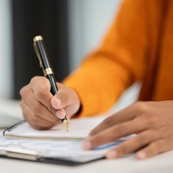 A person taking notes or taking a survey