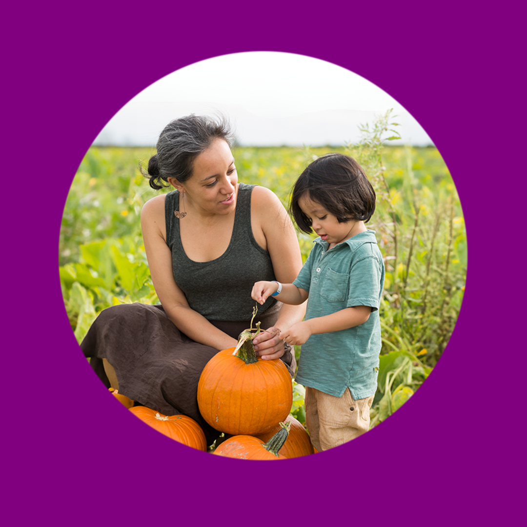 mother and child in a pumpkin patch
