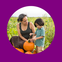 mother and child in a pumpkin patch