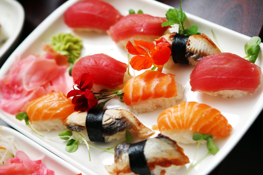 A plate of assorted raw fish (sashimi) sushi.