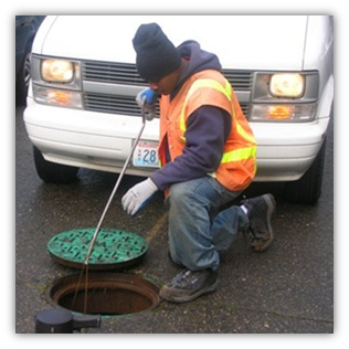 Staff setting rat bait in Seattle's sewer system