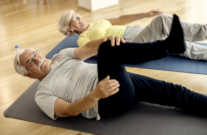 An elder couple working out in a gym