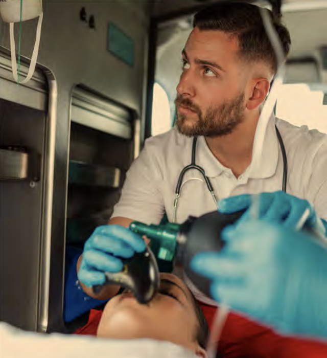 A paramedic in action assisting a patient in an emergency
