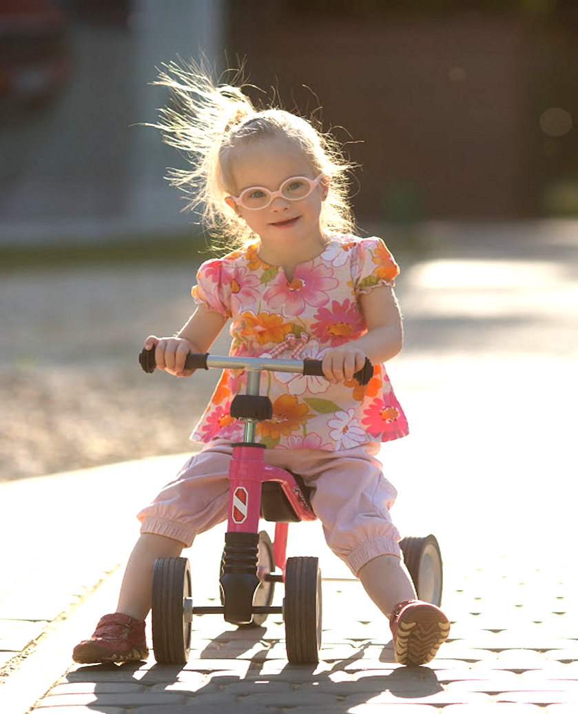Special needs girl on a tricycle