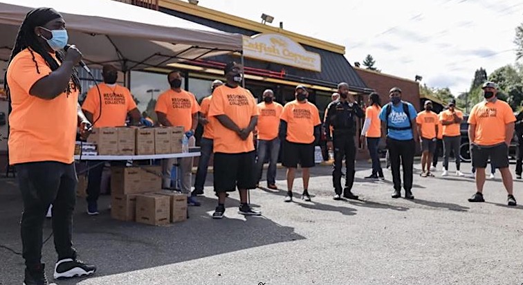 Regional Peacekeepers Collective distributes gun lockboxes during a commemorative event on National Gun Violence Awareness Day