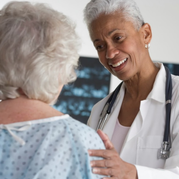 Female doctor examining an elder female patient