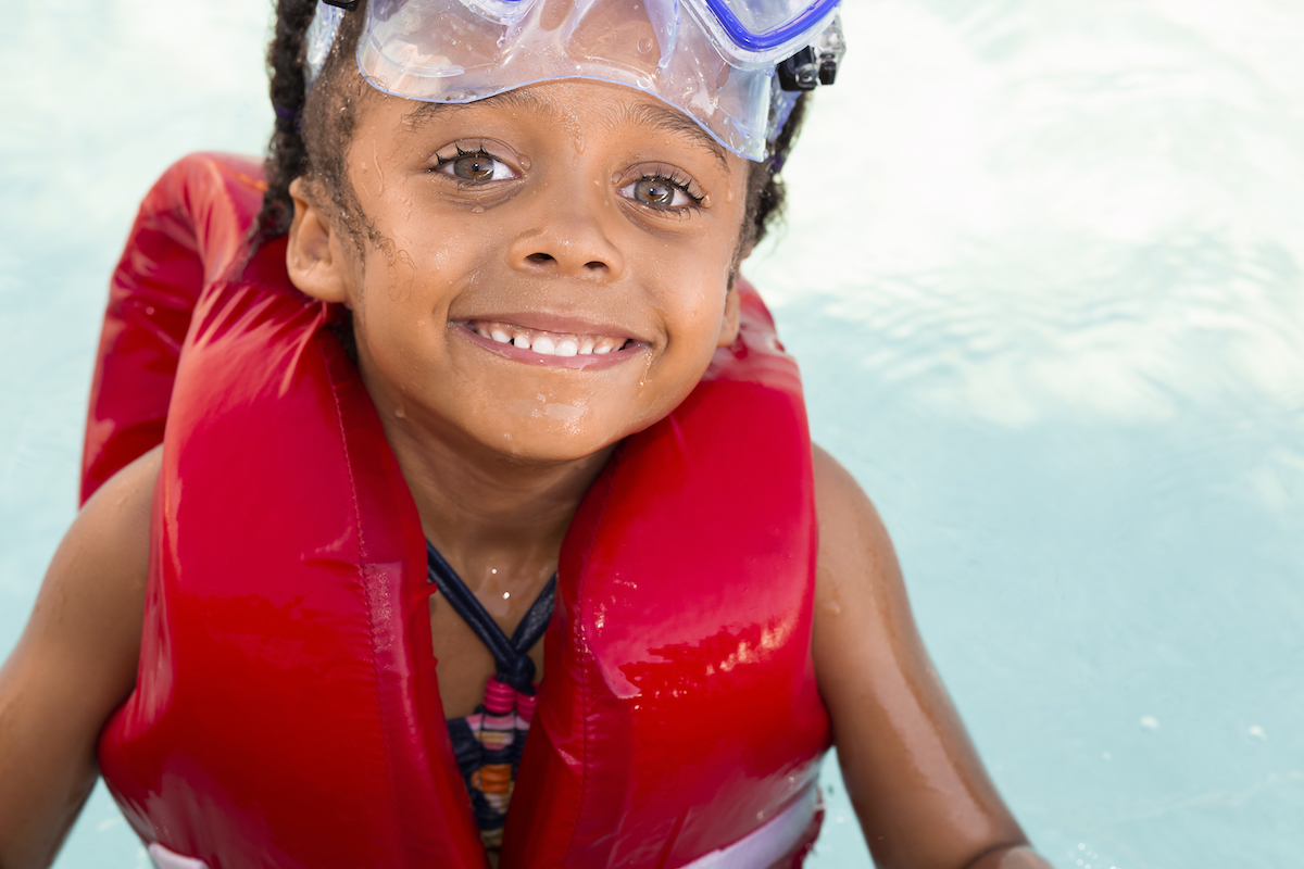 Child smiling wearing a lifejacket