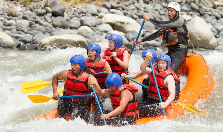 River rafting with life jackets and helmets