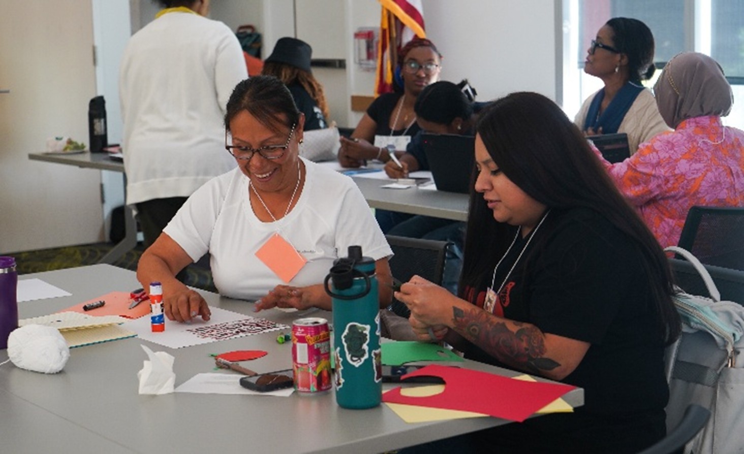 photo of two people cutting shapes out of construction paper with scissors